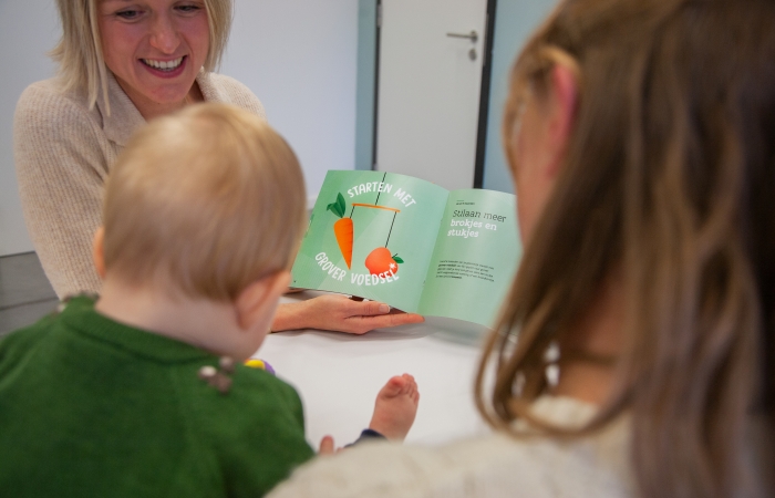 verpleegkundige toont brochure vaste voeding