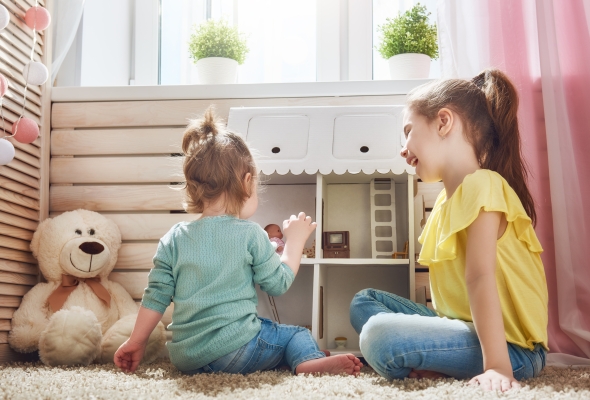kinderen spelen met poppenhuis