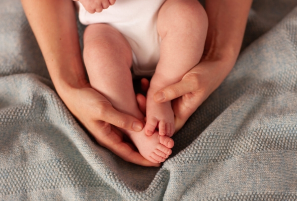 babyvoeten in handen omhelsing